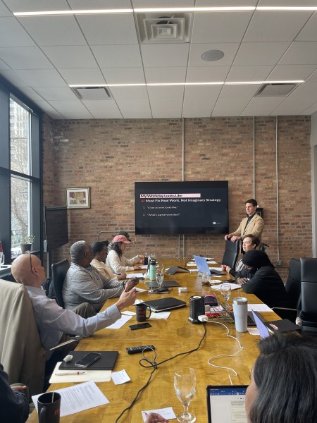 Photo of the AI Workshop: Define Your KPIs to Set Your ROIs, showing professional participants in Chicago, Illinois at Mox.E asking a question for best practices to use AI in their daily work.