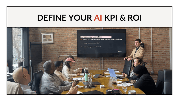 Logan Monday facilitating the Define Your AI KPI and ROI workshop at Entrenuity in Chicago, standing at the head of a conference table with participants and a workshop slide visible on screen behind him.
