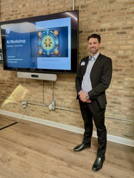 Logan Monday standing in front of a screen displaying the Build Your AI Dream Team workshop title slide at Entrenuity in Chicago.