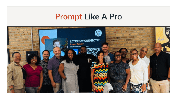 Logan Monday with workshop participants following the Prompt Like a Pro session, group photo with a Logan Monday PowerPoint slide visible on screen behind the group.